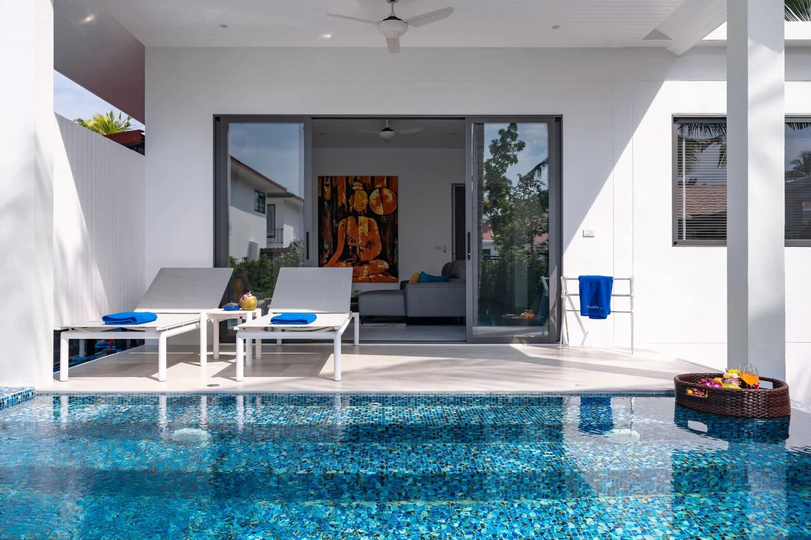 Poolside seating surrounded by tropical plants